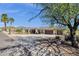 Expansive single-story home with a three-car garage, desert landscaping, and circular driveway at 15620 E Palomino Blvd, Fountain Hills, AZ 85268