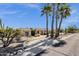Desert property featuring mature palm trees, cactus, and meticulous rock landscaping at 15620 E Palomino Blvd, Fountain Hills, AZ 85268