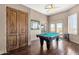 Spacious game room featuring a pool table, wood floors, and natural light from the windows at 15620 E Palomino Blvd, Fountain Hills, AZ 85268