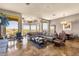 Comfortable living room featuring tile floors, a sectional sofa, and abundant natural light at 15620 E Palomino Blvd, Fountain Hills, AZ 85268