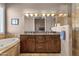 Luxurious main bathroom featuring double sinks, a soaking tub, travertine floors, and a glass-enclosed shower at 15620 E Palomino Blvd, Fountain Hills, AZ 85268