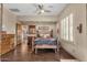 Inviting bedroom with iron bed, hardwood floors, ceiling fan, and plantation shutters at 15620 E Palomino Blvd, Fountain Hills, AZ 85268