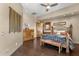 Inviting bedroom with iron bed, hardwood floors, ceiling fan, and dresser at 15620 E Palomino Blvd, Fountain Hills, AZ 85268