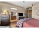 Comfortable main bedroom featuring a tv, dresser, and attached bathroom with dual sinks at 15620 E Palomino Blvd, Fountain Hills, AZ 85268