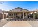 Backyard patio with dining and seating spots, featuring a grill and brick flooring for entertaining and leisure at 16232 W Montoya Dr, Surprise, AZ 85374