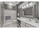Bathroom featuring a glass enclosed shower, vanity with storage, and tiled floors at 16232 W Montoya Dr, Surprise, AZ 85374