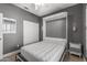 Neutral-toned bedroom with a murphy bed, side table, and closet, offering space-saving design and functionality at 16232 W Montoya Dr, Surprise, AZ 85374