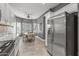 Open-concept dining area with a ceiling fan, a table and chairs, and stainless steel refrigerator at 16232 W Montoya Dr, Surprise, AZ 85374