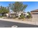 Inviting single-story house with desert landscaping, a mature tree, and a well-maintained lawn at 16232 W Montoya Dr, Surprise, AZ 85374