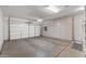 Spacious garage with ample storage cabinets and an overhead door, perfect for parking and organization at 16232 W Montoya Dr, Surprise, AZ 85374