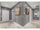 Hallway with beautiful wall art, neutral paint, tiled floors and doors to other rooms at 16232 W Montoya Dr, Surprise, AZ 85374