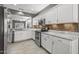 Well-lit kitchen with stainless steel appliances, granite counters, and access to the dining area at 16232 W Montoya Dr, Surprise, AZ 85374