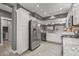 Bright kitchen with stainless steel appliances, granite countertops, and white cabinetry offering modern functionality at 16232 W Montoya Dr, Surprise, AZ 85374