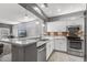 Bright kitchen featuring stainless steel appliances, white cabinetry, and granite countertops at 16232 W Montoya Dr, Surprise, AZ 85374