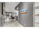 Open-concept living space with tile flooring, gray walls, and a seamless transition to the kitchen at 16232 W Montoya Dr, Surprise, AZ 85374