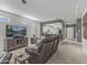Living room featuring tile floors, ceiling fan, and a seamless transition to the kitchen area at 16232 W Montoya Dr, Surprise, AZ 85374