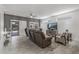 Comfortable living room with tile floors, ceiling fan, with views of the backyard at 16232 W Montoya Dr, Surprise, AZ 85374