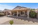 Outdoor patio with pergola cover, seating, and gravel landscaping creates a cozy and inviting backyard space at 16232 W Montoya Dr, Surprise, AZ 85374