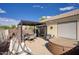 Enjoy the sunny backyard patio with seating, cushioned swing, hot tub, and desert landscape at 16836 E Mirage Crossing Ct # B, Fountain Hills, AZ 85268