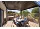 Covered patio featuring a dining set, cushioned swing, and hot tub for outdoor entertaining at 16836 E Mirage Crossing Ct # B, Fountain Hills, AZ 85268
