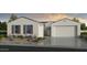 Beautiful single-story home featuring a two-car garage, desert landscaping, and neutral exterior paint at 17118 W Hackamore Dr, Surprise, AZ 85387