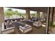 Comfortable outdoor living space with plush seating and stone pillars, perfect for relaxation and socializing at 17118 W Hackamore Dr, Surprise, AZ 85387