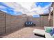 Backyard with a brick patio, block wall, and outdoor seating at 17431 W Via De Luna Dr, Surprise, AZ 85387