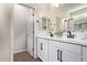 Bathroom featuring a double sink vanity with black faucets and modern white cabinets at 17431 W Via De Luna Dr, Surprise, AZ 85387