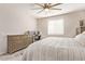Bedroom with a desk, large dresser and a plush bed for ultimate comfort at 17431 W Via De Luna Dr, Surprise, AZ 85387