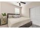 Bedroom features a ceiling fan, a plush bed, and a quaint side table at 17431 W Via De Luna Dr, Surprise, AZ 85387