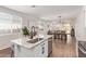 Bright kitchen with granite countertops, an undermount sink, and stainless steel appliances overlooking the dining and living areas at 17431 W Via De Luna Dr, Surprise, AZ 85387