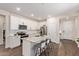 Well-appointed kitchen featuring white cabinets, granite countertops, stainless steel appliances, and a convenient center island at 17431 W Via De Luna Dr, Surprise, AZ 85387