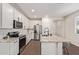 Modern kitchen with stainless steel appliances, white cabinets, granite countertops, and ample counter space at 17431 W Via De Luna Dr, Surprise, AZ 85387