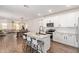 A stylish eat-in kitchen with granite countertops, white cabinetry, stainless steel appliances, and a breakfast bar at 17431 W Via De Luna Dr, Surprise, AZ 85387
