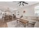 Open concept living space features a large sectional sofa, dining area, and view of the modern kitchen at 17431 W Via De Luna Dr, Surprise, AZ 85387