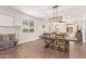 Bright living space offering a view into the modern kitchen, with an open dining area and lots of natural light at 17431 W Via De Luna Dr, Surprise, AZ 85387