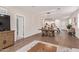 Bright living space offering a view into the modern kitchen, with an open dining area and lots of natural light at 17431 W Via De Luna Dr, Surprise, AZ 85387