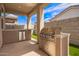Backyard featuring an outdoor kitchen area and artificial grass at 17431 W Via De Luna Dr, Surprise, AZ 85387