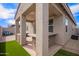 Covered patio featuring an outdoor kitchen and artificial grass at 17431 W Via De Luna Dr, Surprise, AZ 85387