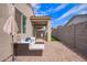 A spacious patio with cushioned seating, an umbrella, and a built-in outdoor kitchen area at 17431 W Via De Luna Dr, Surprise, AZ 85387