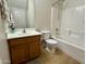 Bathroom with vanity, toilet, and tub with shower, featuring neutral colors and tile accents at 17477 W Woodrow Ln, Surprise, AZ 85388