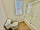 Bathroom featuring a toilet, a shower with glass doors, and a window at 17477 W Woodrow Ln, Surprise, AZ 85388