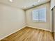 Bedroom featuring wood laminate floors, recessed lighting, and a large window at 17477 W Woodrow Ln, Surprise, AZ 85388