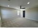 Spacious bedroom featuring neutral carpet, ceiling fan, and a walk-in closet at 17477 W Woodrow Ln, Surprise, AZ 85388