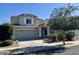 Charming two-story home features a well-maintained front yard and a two car garage at 17477 W Woodrow Ln, Surprise, AZ 85388