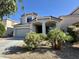 Charming home with manicured landscaping, desert plants, and attached two-car garage at 17477 W Woodrow Ln, Surprise, AZ 85388