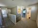Upstairs hallway with access to bedrooms, bathrooms, and a stairway at 17477 W Woodrow Ln, Surprise, AZ 85388