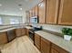 Updated kitchen features wood cabinetry, granite counters, and stainless steel appliances at 17477 W Woodrow Ln, Surprise, AZ 85388