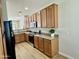 Modern kitchen features wood cabinets, stainless steel appliances, granite countertops, and recessed lighting at 17477 W Woodrow Ln, Surprise, AZ 85388