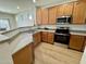 Spacious kitchen features wooden cabinets, stainless appliances, and granite countertops at 17477 W Woodrow Ln, Surprise, AZ 85388